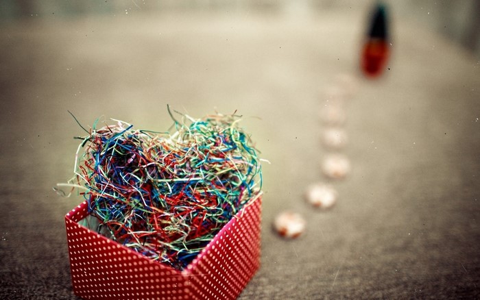 Heart-shaped shredded paper in a polka dot box