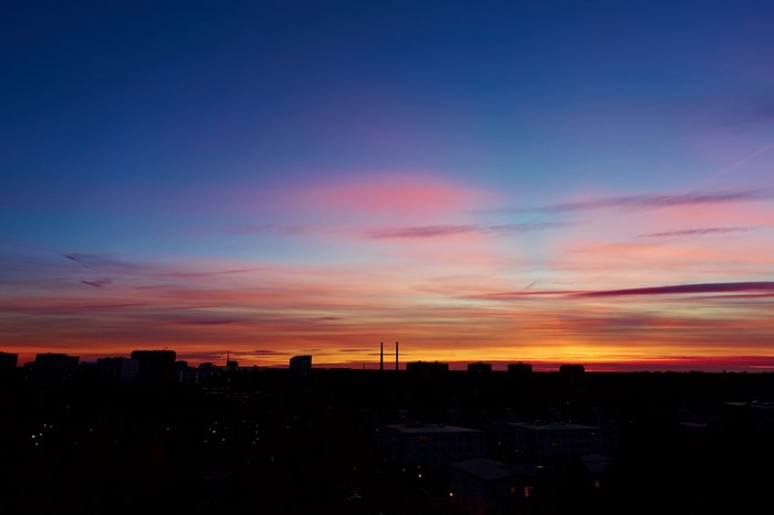 Sunset over city skyline with colorful sky