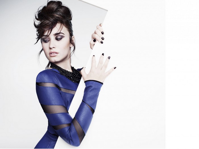 Demi Lovato in blue clothing with black necklace