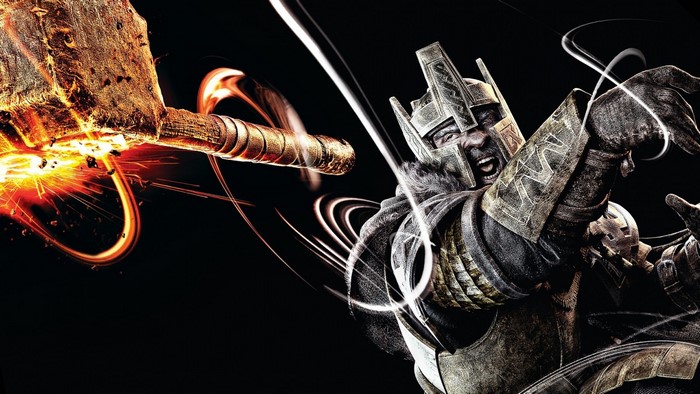 Warrior with a flaming hammer in darkness