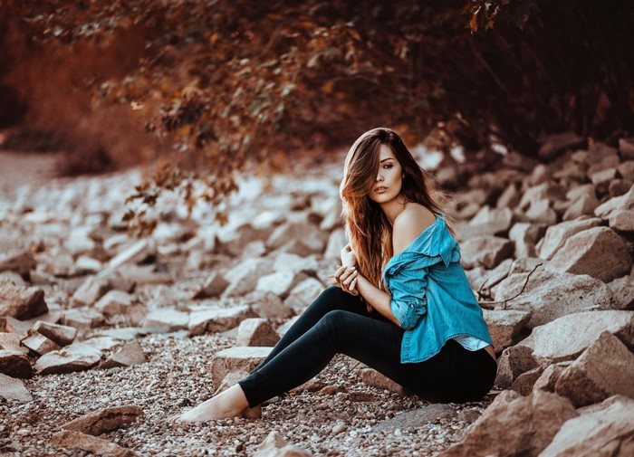 Woman sitting on rocks outdoors
