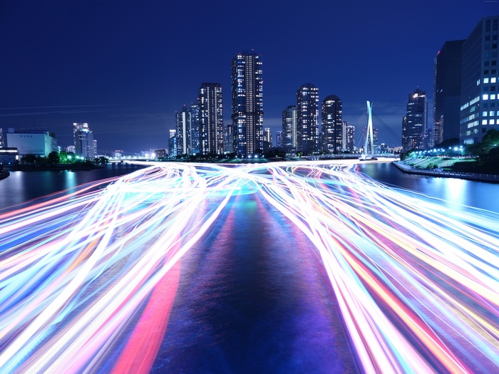 Cityscape at Night with Light Trails on River