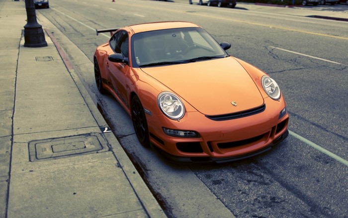 Orange Porsche 911 GT3 parked on a street
