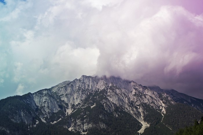 Mountain range with clouds and trees