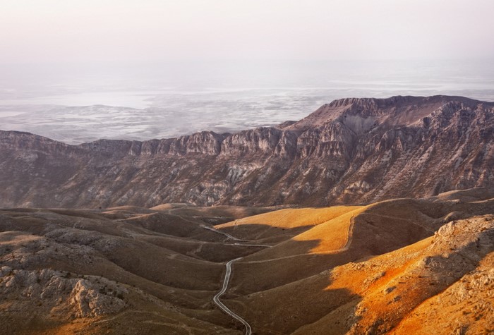 Mountainous landscape with a winding road through hills