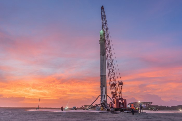 SpaceX Falcon 9 rocket on launchpad at sunset