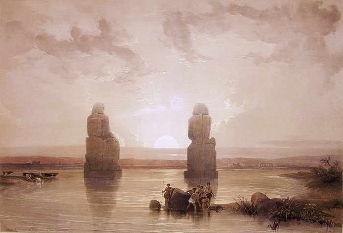 Colossi of Memnon at sunrise over the Nile River