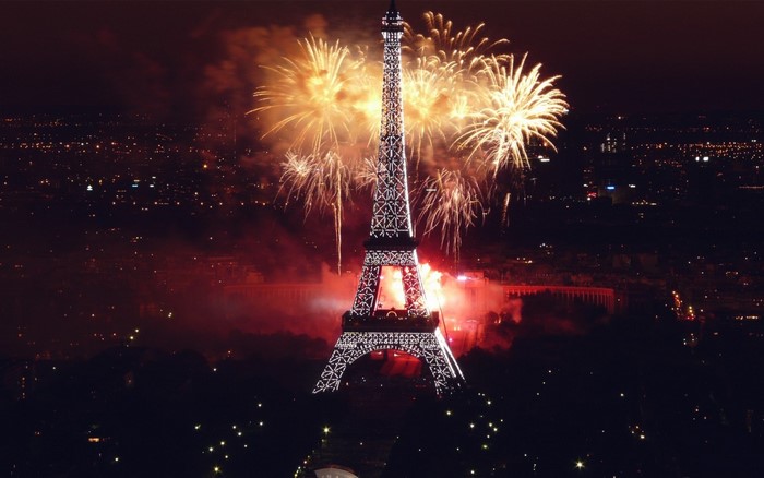 Eiffel Tower illuminated during fireworks display in Paris