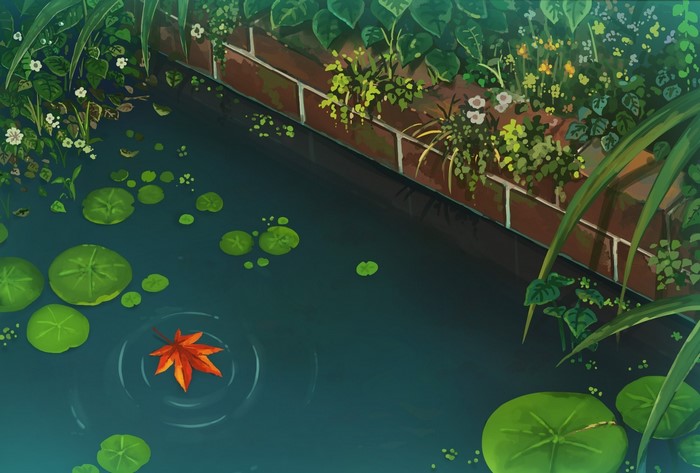 A Japanese garden pond with lily pads and a fallen leaf