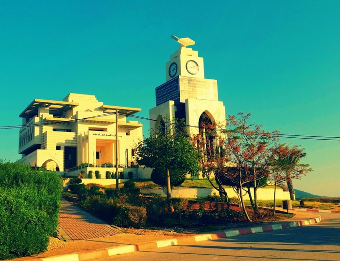 University building and clock tower with trees