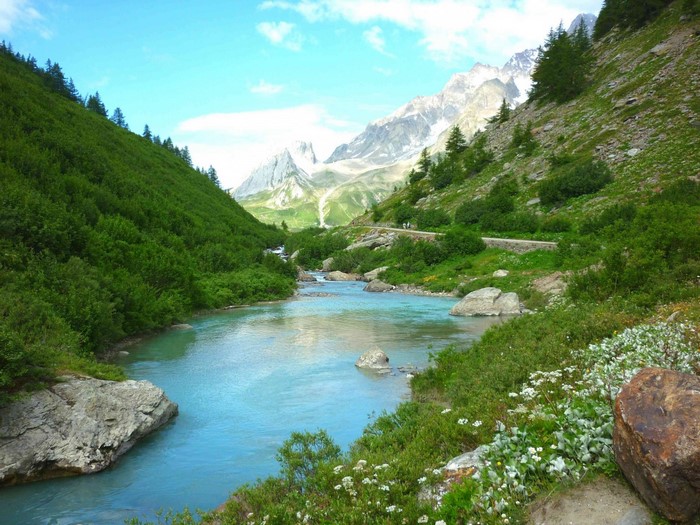 Turquoise river flowing through a green mountain valley