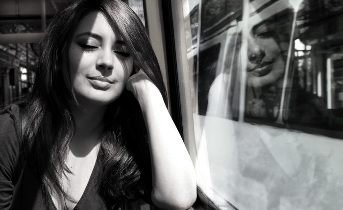 Woman with closed eyes on a train