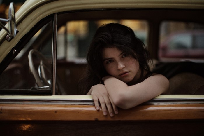Woman leaning on car window