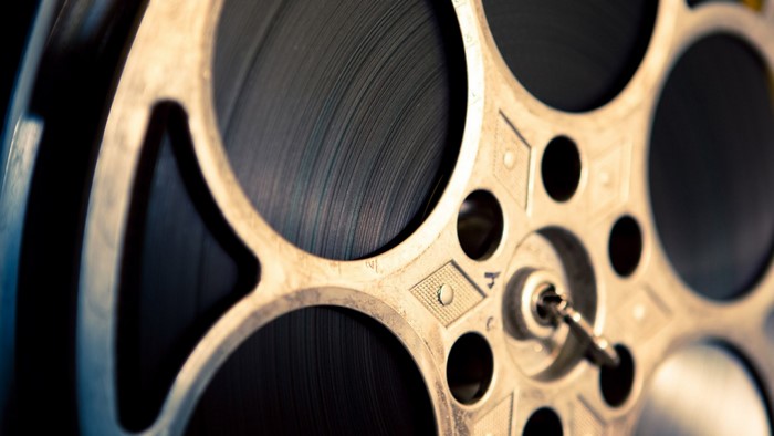 Close-up of a vintage film reel with a key