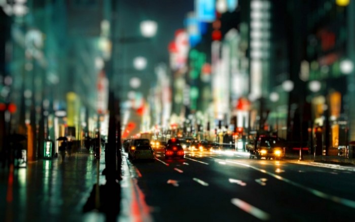 City street at night with traffic and pedestrians