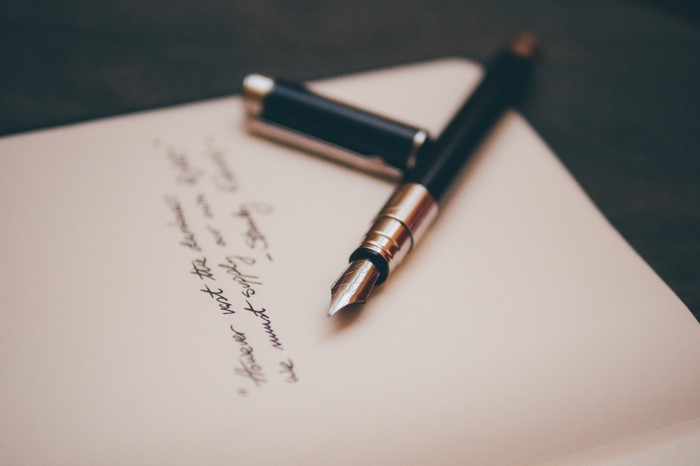 Fountain pen on a notebook with handwritten text
