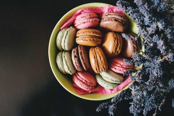 Bowl of colorful macarons with lavender