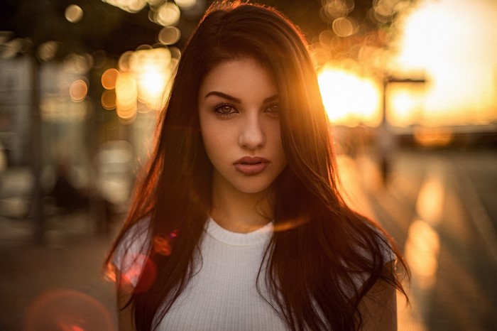 Woman with long brown hair at sunset