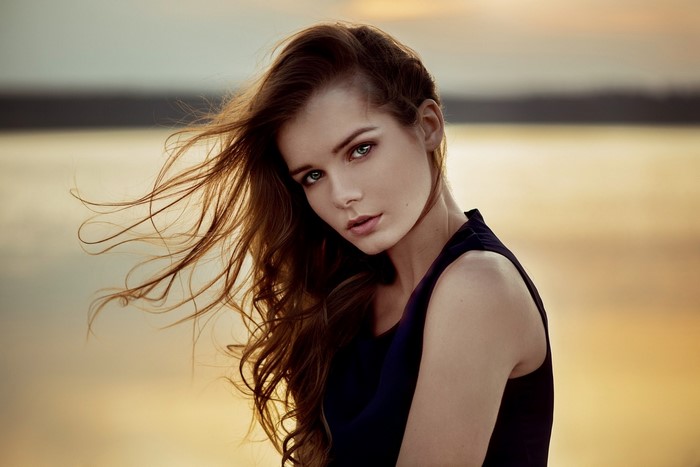 Woman with long brown hair in a dark dress