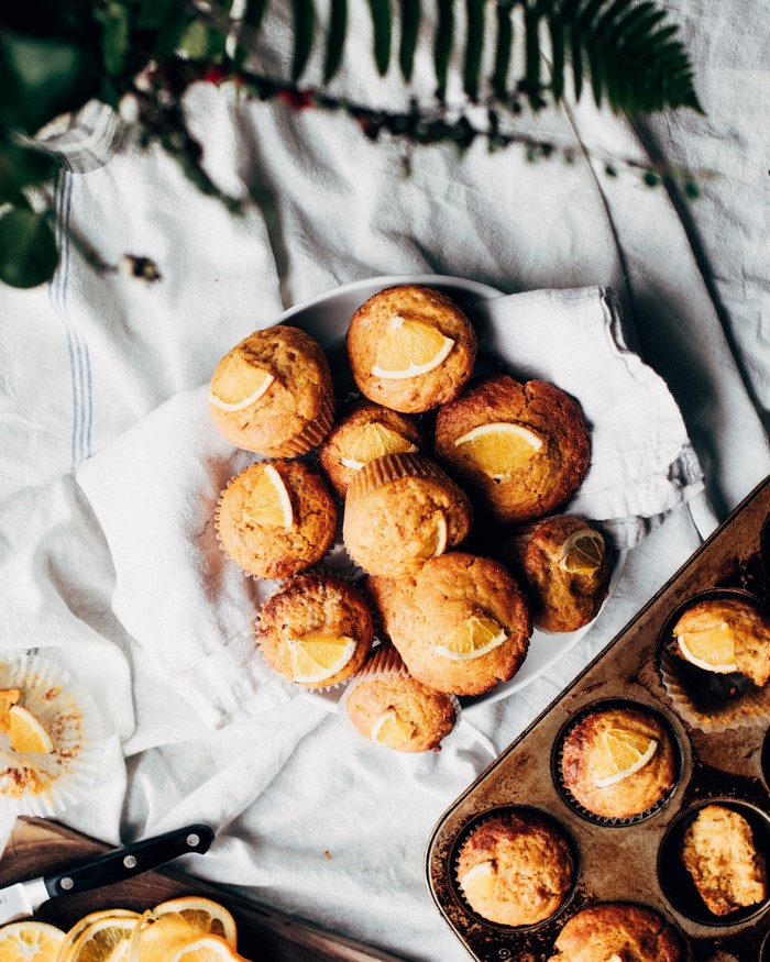 Orange Muffins in a Muffin Tin and Bowl