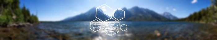 Blurred landscape with mountains, lake, and hexagons