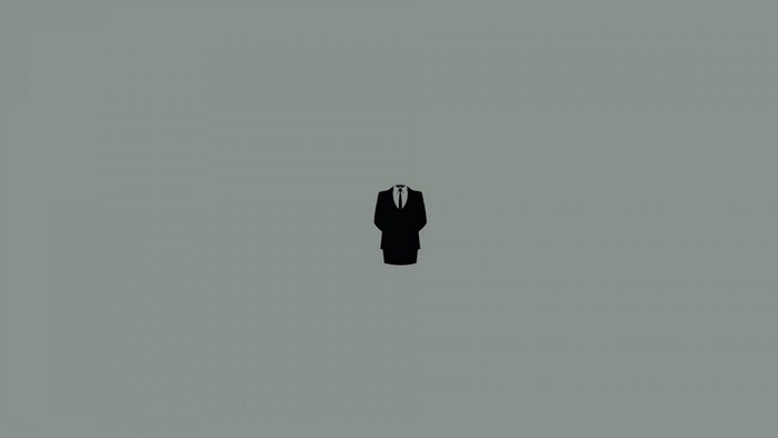 Minimalist black suit with tie on grey background