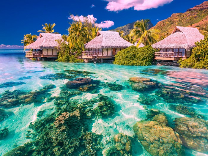 Overwater bungalows in a tropical lagoon with coral reefs