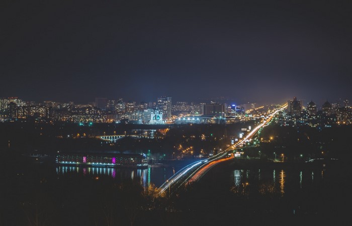 Cityscape at Night with Bridge and Reflections