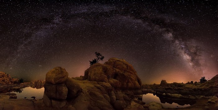 Milky Way galaxy over rocky landscape at night