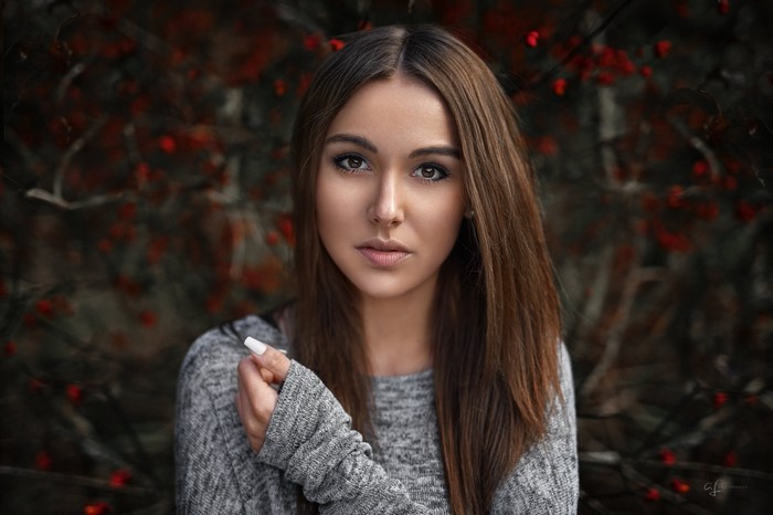 Woman with brown hair in a grey sweater