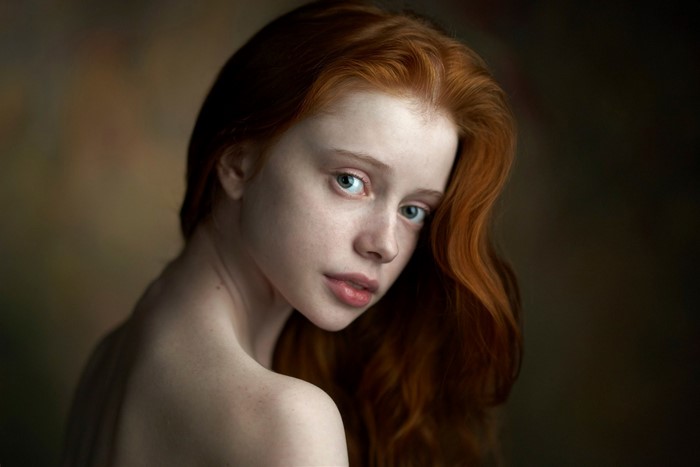 Portrait of a young redhead woman with green eyes