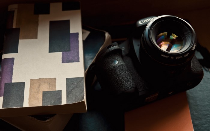 Canon DSLR camera and book with abstract cover