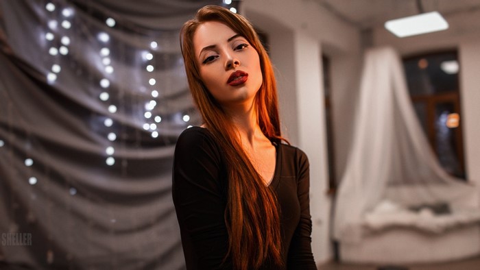 Woman with long red hair and red lipstick