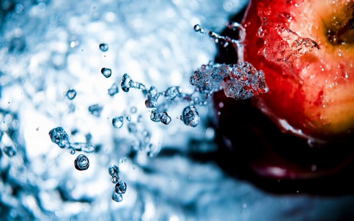 Close-up of an apple with water splashes