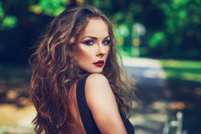 Woman with long brown hair and red lipstick