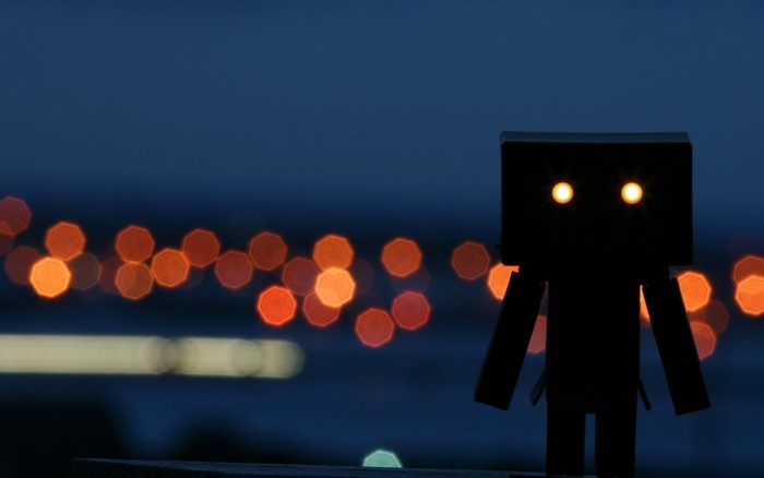 Black figure with glowing eyes at night with bokeh lights