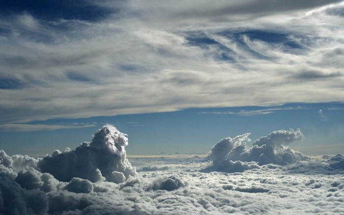 Lion shaped cloud formation above a sea of clouds