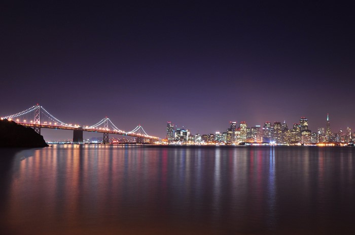 San Francisco Bay Bridge and skyline at night
