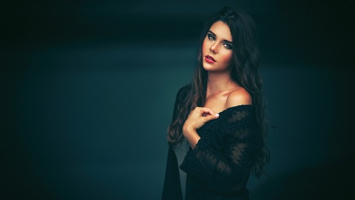 Woman in black lace top posing for a photoshoot