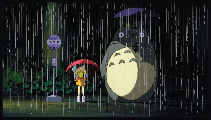 Totoro and Satsuki at a bus stop in the rain