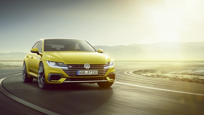Yellow Volkswagen Arteon R-Line driving on a road