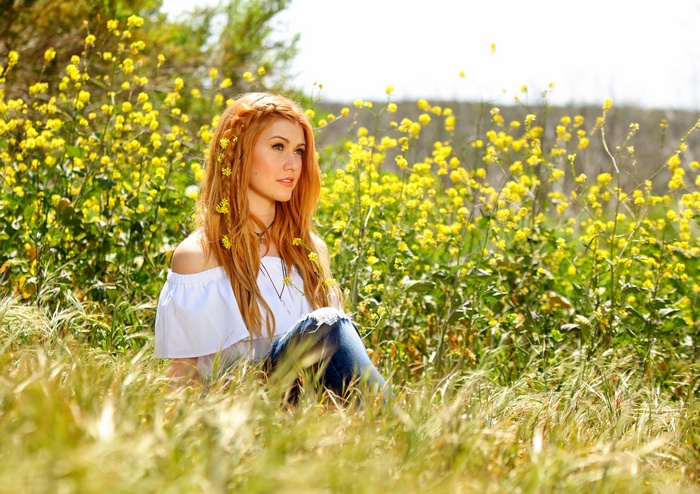 Katherine McNamara in a field of yellow flowers