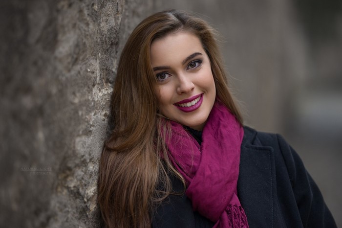 Woman with long brown hair and pink scarf