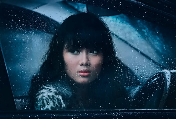 Woman in car on a rainy night