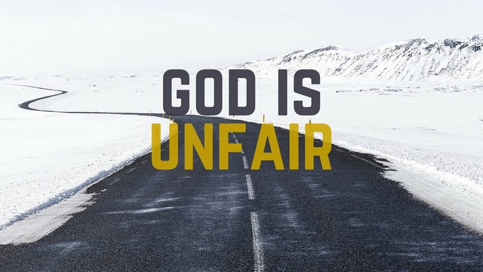 God is Unfair text on a snowy road