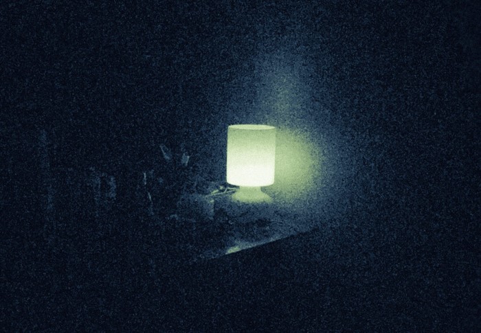 A glowing lamp in a dark room