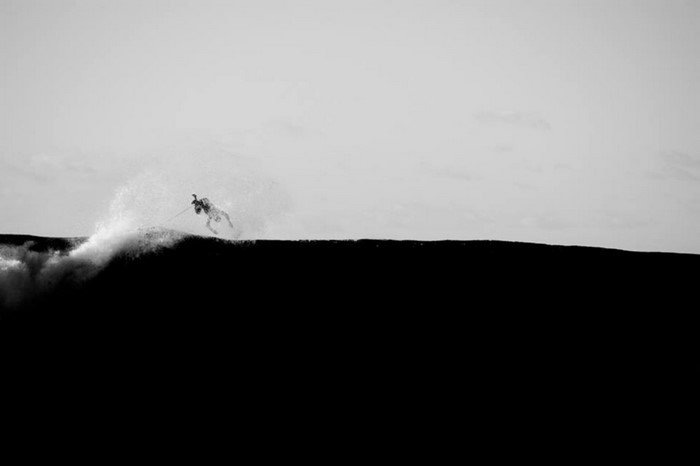 Surfer riding a wave in monochrome