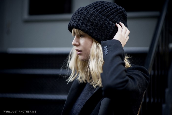 Woman wearing a black beanie and coat