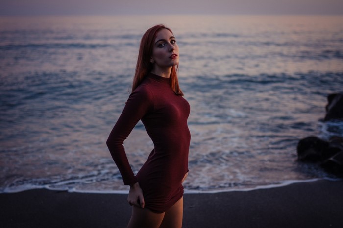 Redhead Woman in Burgundy Dress by the Sea at Sunset