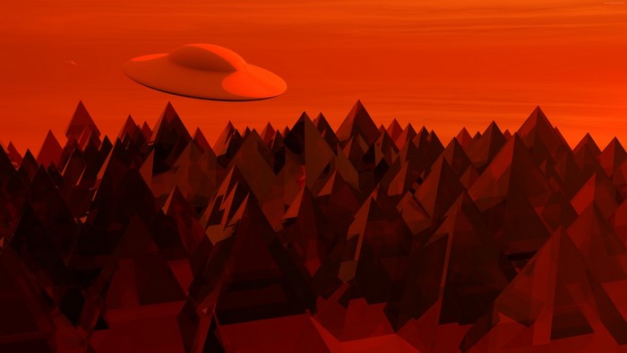 UFO flying over red mountains at sunset